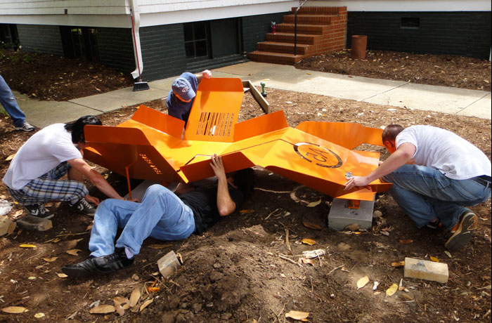 Students attaching sculpture to footers